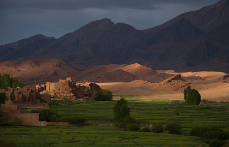 Kasbahs caught between thnderclouds and the shadow of the mounta