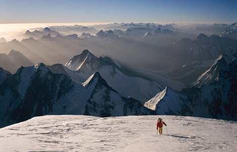 Dawn on K2 with view into China. Alan Hinkes. 8000 metres plus -­‐ the climber below is bent double with the effort. What a time to take a picture!