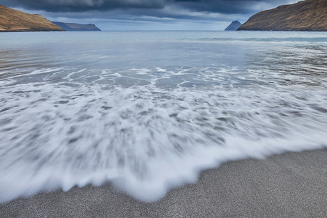 The beach of Sandvík with views of the islands of Stóra Dímun on the left and Lítla Dímun on the right in the far background.