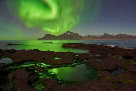 Amazing display of auroras dancing in the night sky of Gjógv.