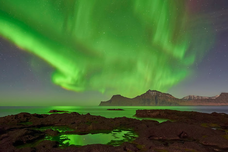 A huge aurora over the mountains of Kalsoy