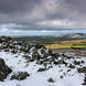 Kate Maxwell - Looking towards Brown Clee (Shropshire’s highest point) over the collapsed Bronze Age hillfort wall.