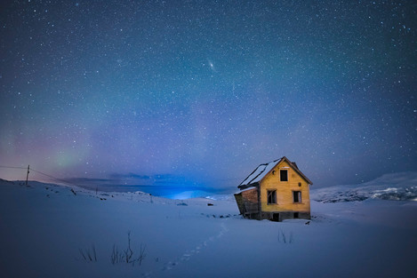 Cold and alone: My initial intent was to produce an attractive image of the hut and the aurora, but in post processing I realised the single line of footsteps in the snow and the stars in the sky created story of being cold and alone.