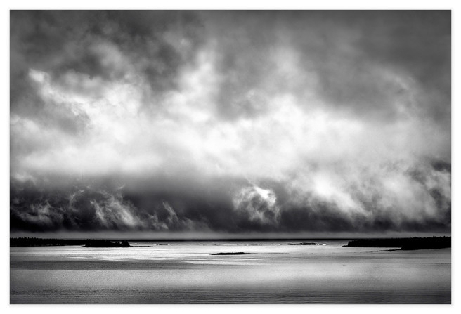 <strong>The Ends of the Earth</strong> is where I live, at the remote eastern tip of Nova Scotia, and this is the view from my studio window as shafts of sunlight spar with storm clouds for dominance over the sea. The ever-changing skyscape here is a constant source of inspiration for my work.