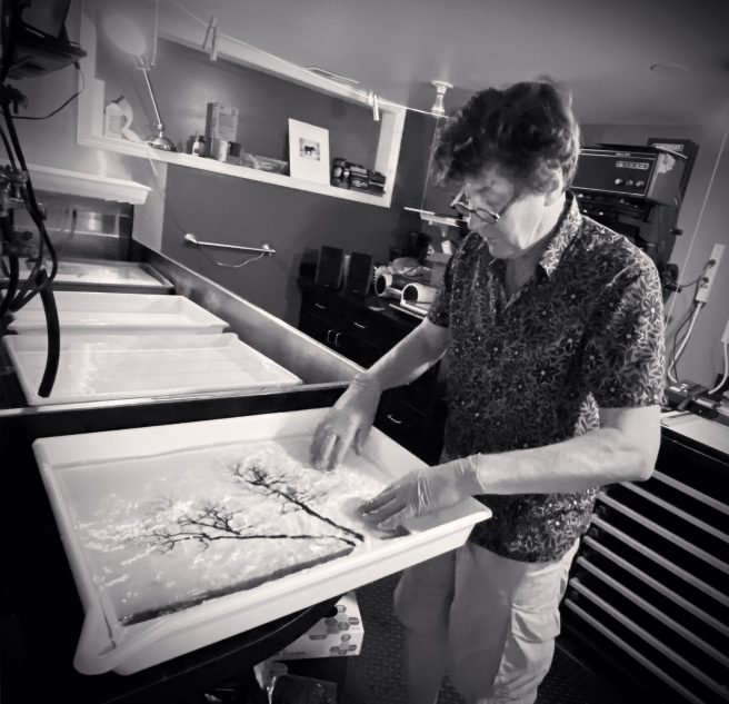 Michael Kenna Working On A 15x15” Print Of Two Leaning Trees, Study 3, Kussharo Lake, Hokkaido, Japan. 2020 Mamta Kenna 2021